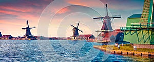 Panorama of authentic Zaandam mills on the water channel photo