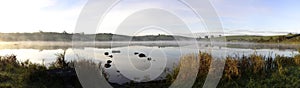 Panorama autumn sunrise on an Irish lake