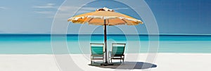 Panorama banner of two chairs and a sun umbrella on an exotic beach on a sunny day with blue water and sunny clear sky