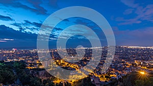 Panorama of Barcelona night to day , Spain, viewed from the Bunkers of Carmel