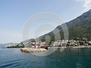 Panorama of Baska Voda in Croatia. View of the marina and Biokovo Mountain from the sea