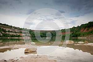 Panorama of a beach of Besenovacko jezero, or lake Besenovo, in Fruska gora mountains, vojvodina, Serbia during a rainy afternoon