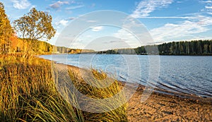 Panorama of beautiful autumn landscape with lake and forest on the Bank of Russia, the Urals