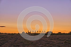 Panorama of beautiful countryside, sunny sunset. On the horizon you can see the ruins of the barn, the grassy field and