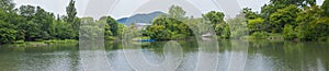 Panorama beautiful landscape view of Lake surrounded with green trees in Nakajima Park Koen in Sapporo City,