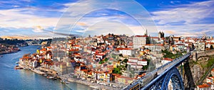 panorama of beautiful Porto over sunset - view with famous bridge of Luis, Portugal