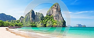 Panorama of beautiful sand Railay beach and thai traditional wooden longtail boat in Krabi province, Thailand