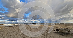 Panorama of beautiful scenic view of stormy Baltic sea, dramatic sky, sandy beach