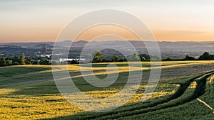 Panorama of the beautiful sunset in western Germany, a field of wheat, in the distance a flowing river, railway bridge and chimney