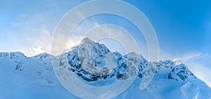 Panorama of beautiful windy weather over high alpine mountains