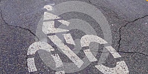 Panorama Bicycle lane sign painted on a road with cracks