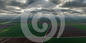 panorama of black sky background with storm clouds. thunder front over fields with sun rays