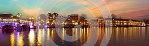 Panorama from the Blauwbrug at the river Amstel in Amsterdam the Netherlands at sunset