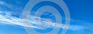 Blue Sky wispy white clouds nature background banner