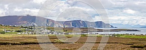 Panorama of bog with village and mountains in background