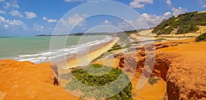 Panorama of brazilian beach with dunes bathed by ocean waves photo