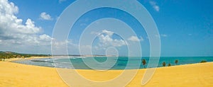 Panorama of brasilian sandy beach bathed by ocean waves photo