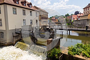 Panorama with bridge and weir at river Regnitz and half-timbered houses in Bamberg, Upper Franconia, Bavaria, Germany