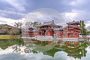 Panorama of Byodo-in Temple in Uji, Kyoto Prefecture, Japan, against a dark cloudy sky