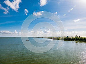 Panorama of calm IJsselmeer lake and artificial island Kornwerderzand, Netherlands