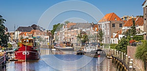 Panorama of a canal with old ships and historical houses in Zwolle