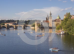 Panorama of Charles bridge over Vltava river and houses of Old Town, Prague, Czech Republic, golden hour light, summer