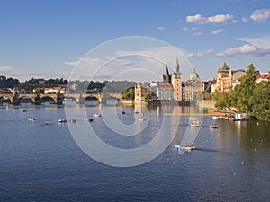 Panorama of Charles bridge over Vltava river and houses of Old Town, Prague, Czech Republic, golden hour light, summer