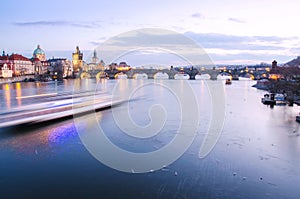 Panorama of Charles Bridge in Prague with motion blured boat, Czech Republic