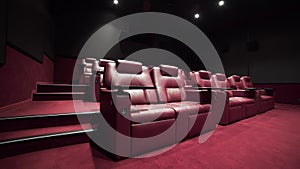 Panorama of the cinema theater with comfort leather armchairs, cinema without people, cinema before the session, vip