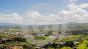 Panorama of the city of Legazpi on the background of the airport. Luzon, Philippines. Timelapse.