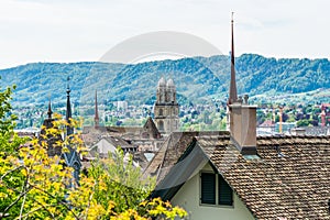 Panorama of city view of old downtown of Zurich city, with beautiful house and Grossmunster Great Church  at the bank of Limmat