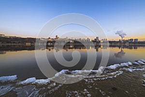 Panorama of the city in winter frozen river