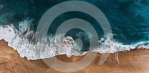 Panorama of a clean beach. Aerial view of the blue ocean waves on the beach. Beautiful sandy beach with blue sea. Lonely sandy