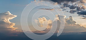 Panorama of clouds in different shapes at dusk