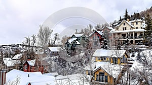 Panorama Cloudy sky over scenic neighborhood community nestled on snowy hill terrain