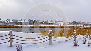 Panorama Clubhouse overlooking lake and homes against cloudy sky on a frosty winter day