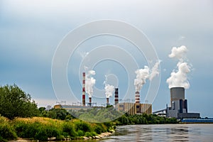 Panorama with a coal-fired power plant in Kozienice. Smoking stacks  and vapor from the cooling towers.