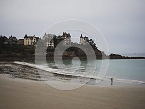 Panorama of coastline shore beach ocean waves castle chateau houses cliff Dinard Ille et Vilaine Bretagne France