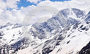 Panorama of a colored mountain landscape with the snow covered mountains