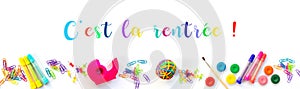Panorama of colorful school supplies  on white background with with text `c`est la rentree` photo