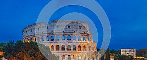 Panorama of Colosseum and Arch of Constantine under blue sky at dusk in Rome, Italy