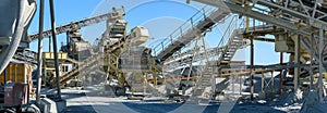 Panorama of conveyors and stone crushing machinery at gravel quarry photo