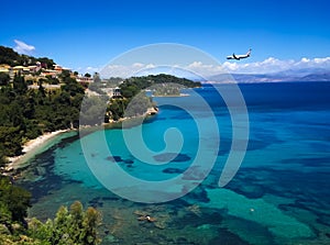 Panorama of Corfu beach and sea with plane overflying to the shore