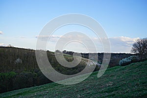 Panorama of the countryside at sunset in the evening light. Beautiful spring landscape in the mountains. Rural landscapes