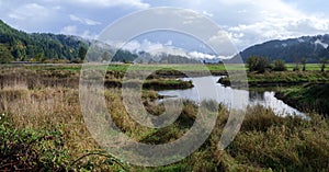 Panorama of the creek and surrounding mountains at the Dean Creek Wildlife Area near Reedsport, Oregon, USA