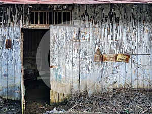 Creepy old house on a dusty road on a sunny day.