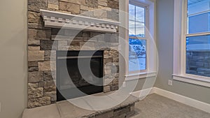 Panorama crop Modern fireplace and decorative shelf against stone brick accent wall of home