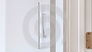 Panorama crop Side view of electrical rocker light switch mounted on white interior wall