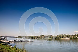 Panorama of the danube river in Mohacs, Hungary, with a ferro boat, Mohacsi komp, ready to cross the Danube from Mohacs to