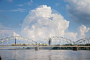 Panorama of the Daugava river in Riga, latvia, with a train from Latvian railways over dzelzcela tilts or Riga Railway Bridge with photo